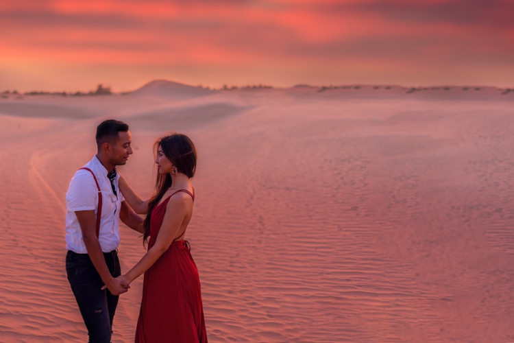 couple holding hands in dubai at sunset