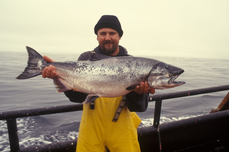 man holding a salmon